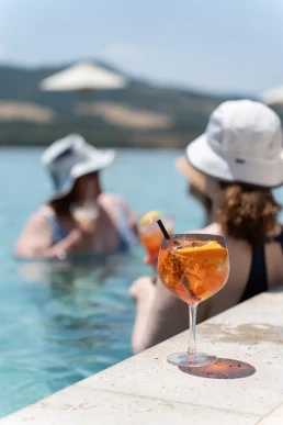 Couple enjoying a relaxed pool party during their wedding weekend