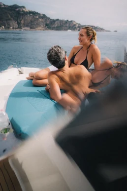 Couple relaxing on a boat trip activity during their wedding weekend