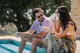 Couple enjoying coffee together beside a villa pool in Sicily