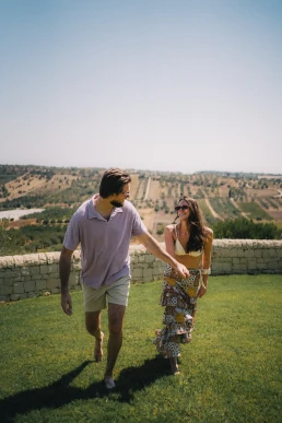 Couple walking together through the countryside after their elopement
