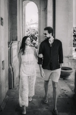 Newlywed couple walking through a historic Sicilian street