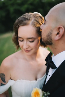 Intimate wedding portrait of a groom kissing the bride during a story-driven wedding film